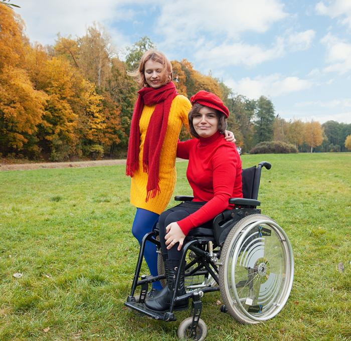 female in wheel chair with a friend