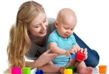 Mother and child playing with blocks.