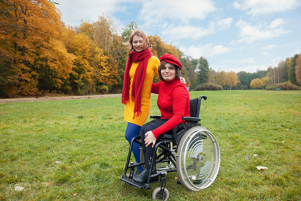 female in wheel chair with a friend