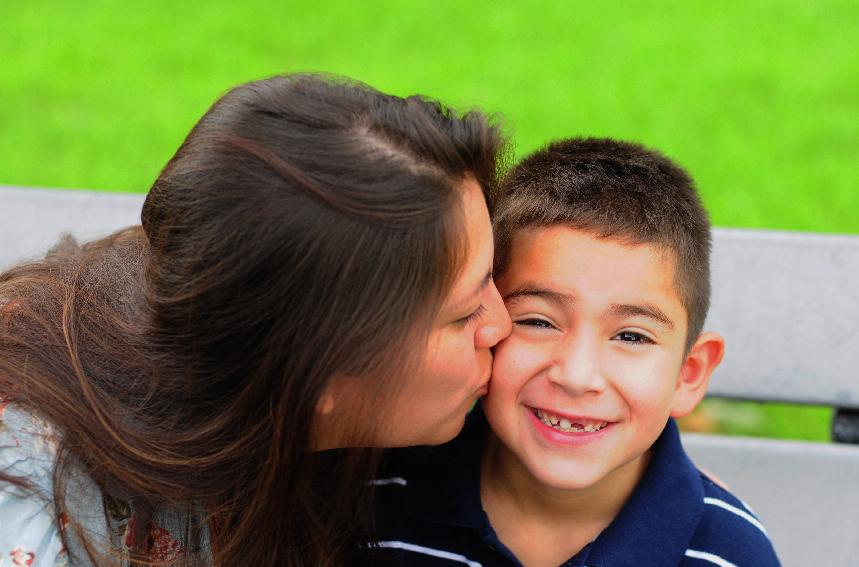 Mom kissing son