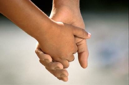 One person's hand holding another person's hand