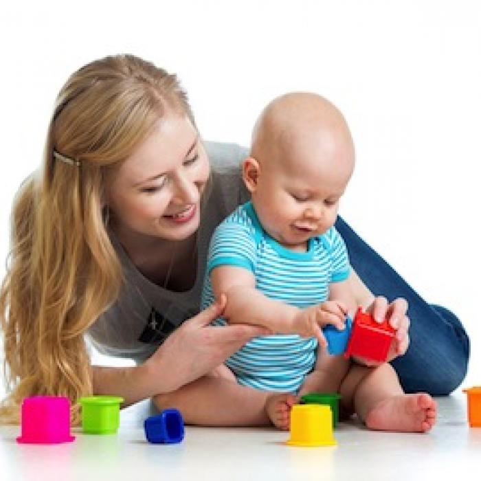Mother and child playing with blocks.
