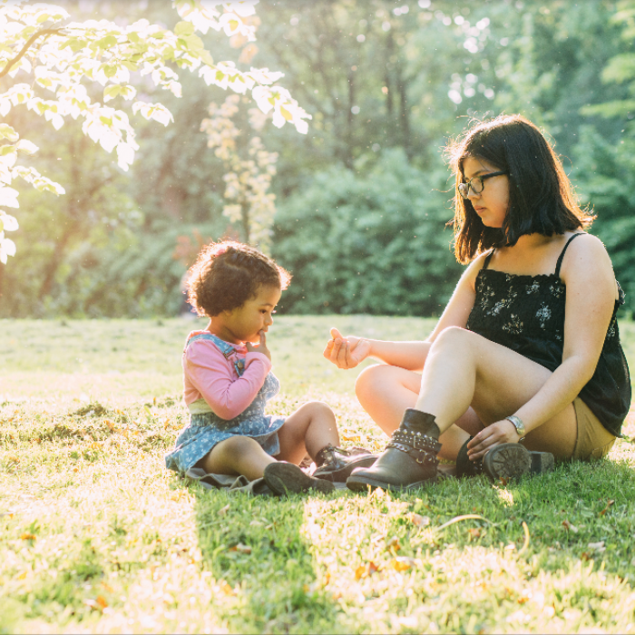 hispanic mother and child in a park on a sunny day