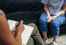Therapist sitting with client writing down notes
