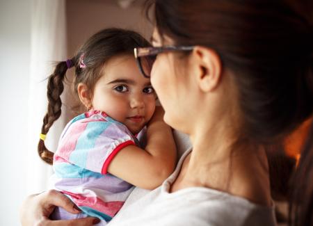 Mother holding a young daughter