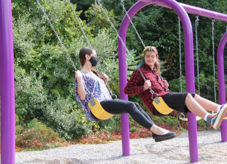 Student and Clinician on swings