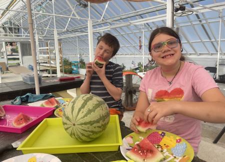 Two children eating watermelon