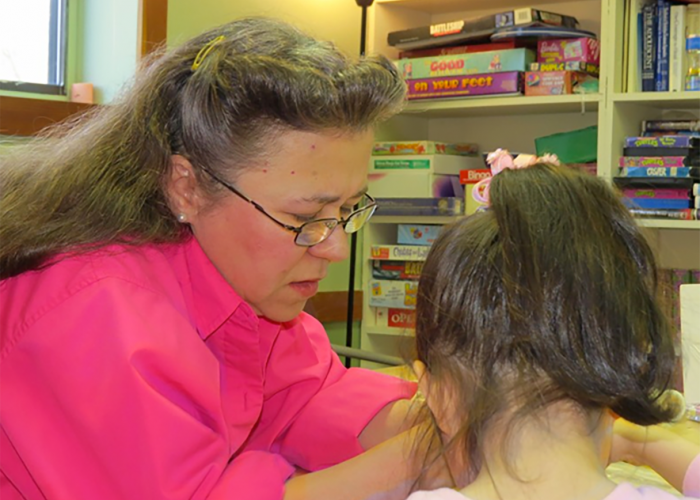 Woman helping child