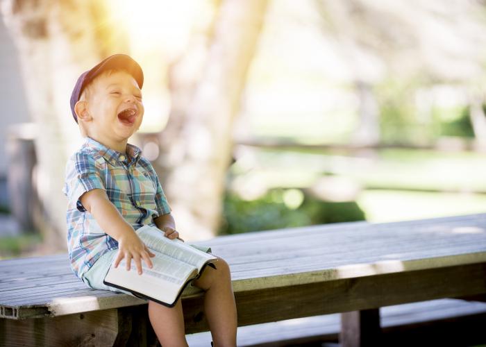 Smiling child reading a book