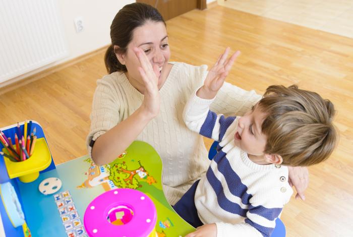 teacher and student high fiving