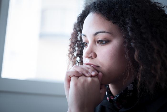 young african american female looking out the window