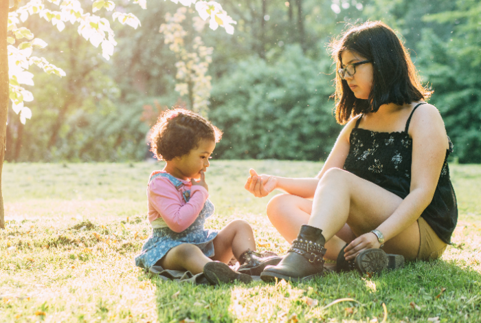 Hispanic mother and child in the park on a sunny day