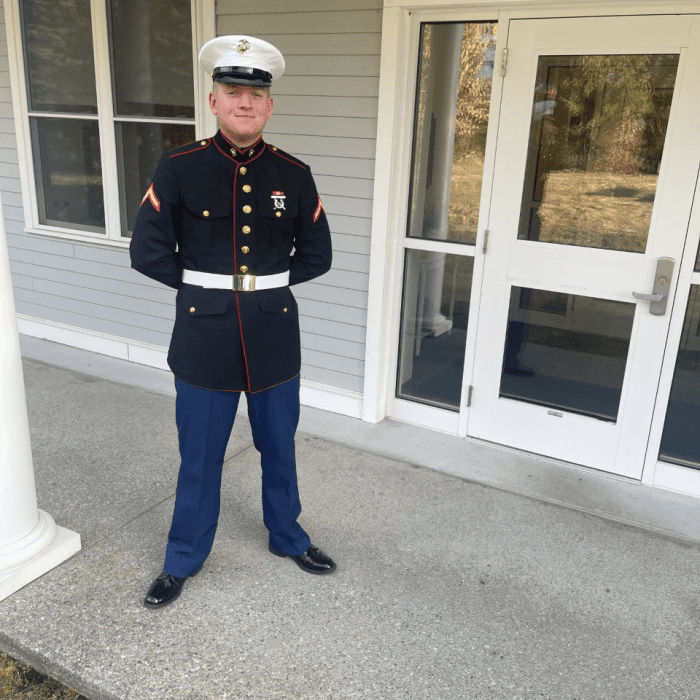 Person in Marine Corps uniform standing outside.