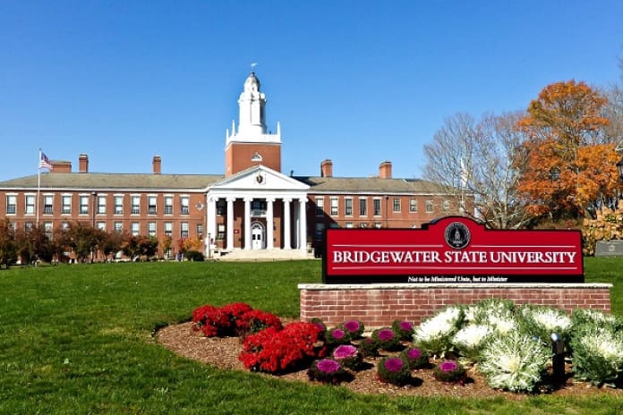 Bridgewater State University building with a sign and landscaped garden in front.