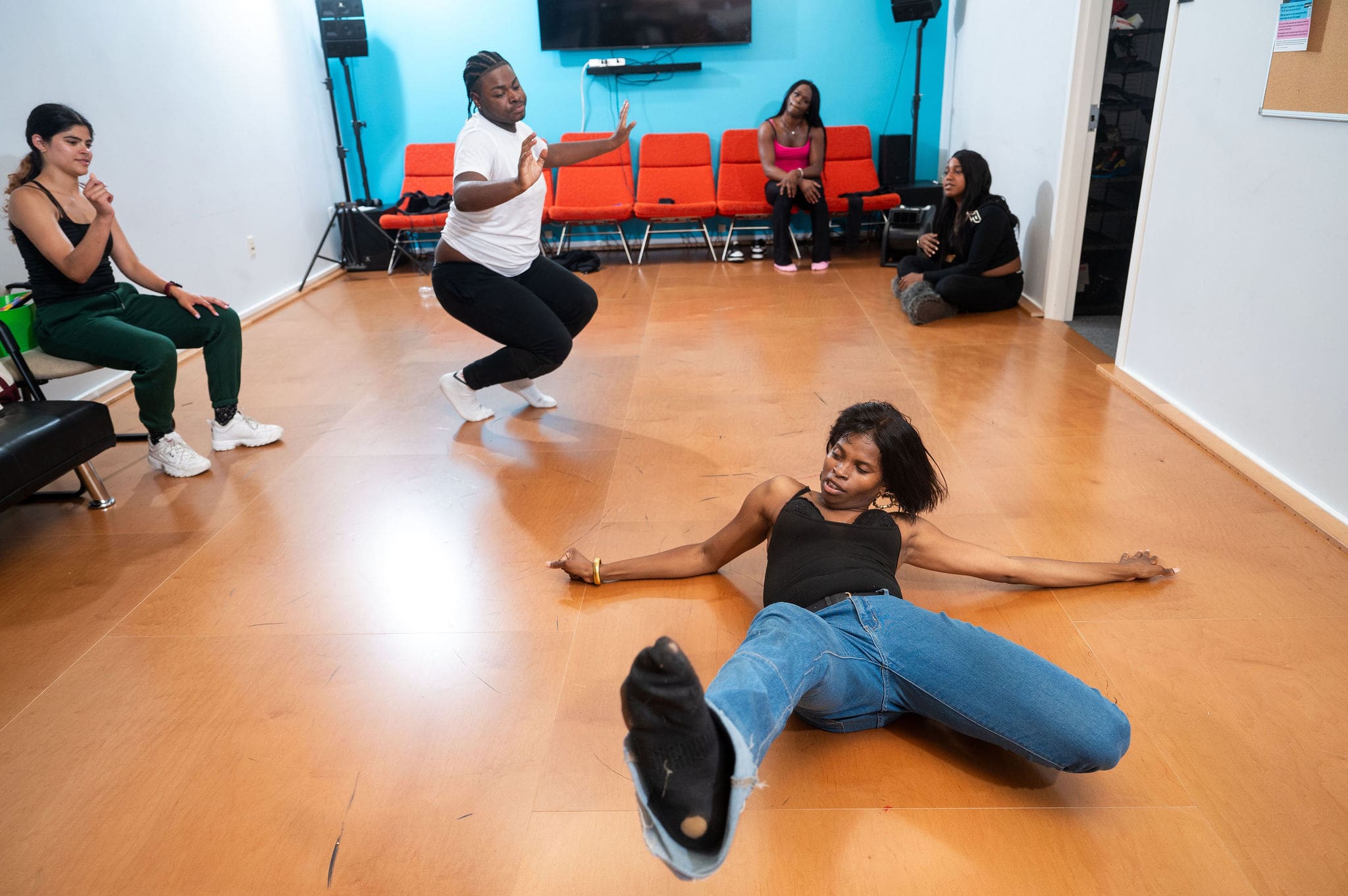 Group of young people dancing in a studio.