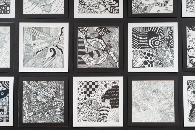 Collection of black-and-white abstract artwork on framed display