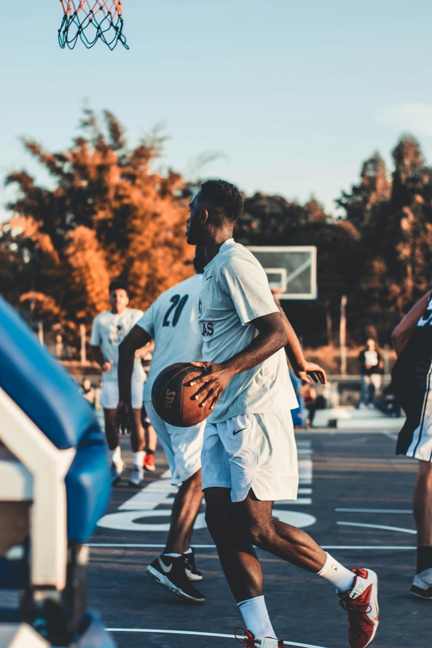 Basketball player dribbling the ball on an outdoor court