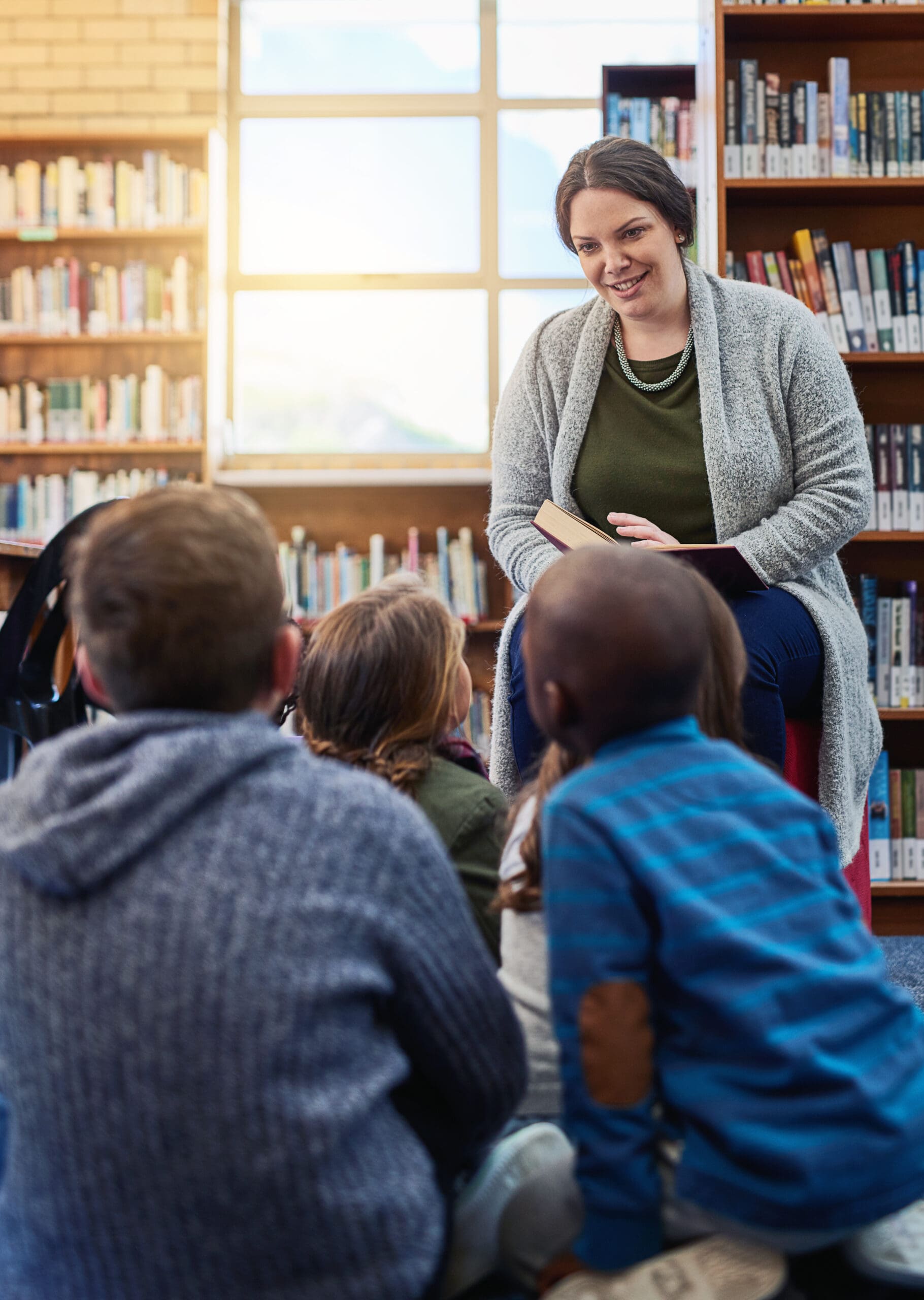 Woman reading to children in a library.