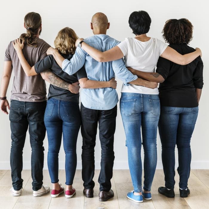 Five people with arms around each other, facing away.